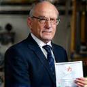 Schweizer Uhrmacher mit Zertifikat und Werkzeugen in Werkstatt